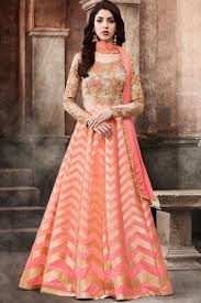 It is a long flowing women's dress usually worn to a formal affair. Beige And Peach Color Dhupion Brocade Fabrics Beautiful Floral Embroidered Party Wear Designer Floorlength Gow Long Anarkali Gown Anarkali Dress Indian Outfits