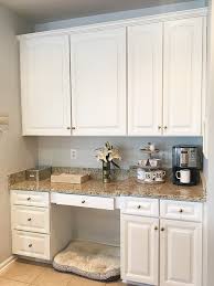 Speed the aging process by dipping the tips of a paintbrush in a color lighter than the cabinets, dabbing the excess onto a cloth until the brush is almost dry and lightly grazing the surface of detail trim, corners, or seams. The Dos And Donts Of Cabinet Painting