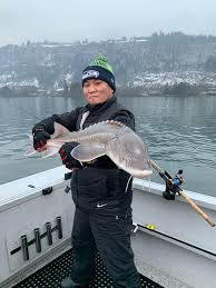 Sturgeon guide tony nootebos holds a young sturgeon, a fish that can grow to hundreds of kilograms during a lifespan that can last more than 100 years. Columbia River Sturgeon Fishing Best Fishing In America
