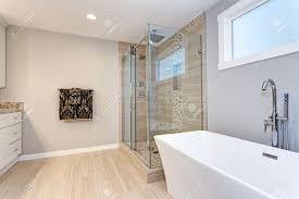 The freestanding tub or its cousin, the slipper tub, add visual impact to what otherwise is a functional space. Light Modern Bathroom Design With Walk In Shower And Freestanding Stock Photo Picture And Royalty Free Image Image 99607368