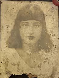 Close up showing detail and antiquing of the face, giving it a vintage  look.