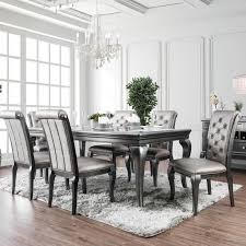 It includes a table and four chairs, so it gives you everything you need for a matching look. 7 Piece Transitional Glam Style Formal Dining Set