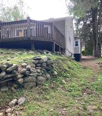 Rock retaining walls have become a widespread landscape choice for builders and homeowners that have a steep slope in their yard and need something to do with it. How Can I Protect My Foundation When Removing Old Retaining Walls And Regrading Home Improvement Stack Exchange