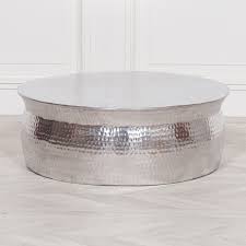 For those in smaller spaces, such as apartments or lofts, opt for a round coffee table that complements the loveseat instead. Aluminium Round Hammered Metal Coffee Table Furniture La Maison Chic Luxury Interiors