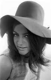 Image of Ann Cave, model, poses with a make up mask, 29th