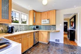 Looking for some contrasting colour combinations for your kitchen cabinets? Modern Light Tone Kitchen Cabinets With Steel Dishwasher Kitchen With Brown Tile Floor And Tile Back Splash Trim Stock Photo Picture And Royalty Free Image Image 34354486