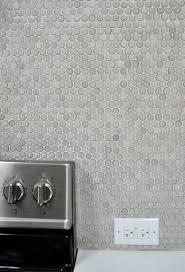Dampen a sponge and wipe down the tumbled marble tile. How To Grout Penny Tile Young House Love