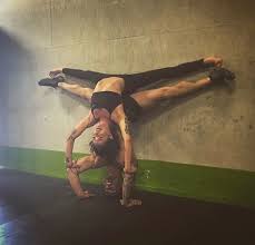 Split Hollow Back Handstand On Elbows Of Split Tripod Headstand Up Against The Wall Acro Yoga Yoga Postures Headstand