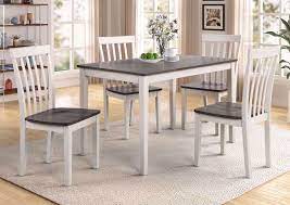 To keep the smoky color of the dining set above from making the room seem dark, the decorator offsets the table with a white rug and accents. Brody 5 Piece Dining Table Set White And Gray Home Furniture Plus Bedding