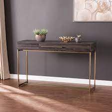The curves of the long oval table shape are contrasted by the several vertical black iron bars that cover the table like a cage, save for the front center. Frondi Long Console Table Black Oak Antique Brass Aiden Lane Target