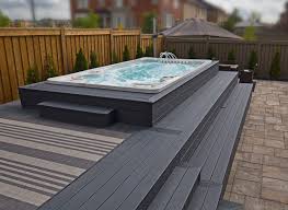 An Incredible Above Ground Swim Spa Installation Featuring A Composite Deck And Stone Patio Homemade Swimming Pools Swimming Pool Decks Swimming Pool Lights