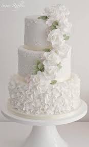 Orchids and cream roses cascade down pleated fondant, adding a stylish twist on traditional white. Weddingcake Wedding Cake Silver Simple Wedding Cake Modern Wedding Cake Romantic Wedding Cake