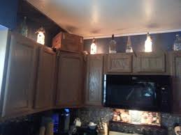 Christmas Lights In Wine Bottles Dressed Up Above My Kitchen Cabinets Above Kitchen Cabinets Kitchen Cabinets Kitchen Cabinets Decor