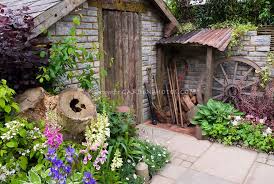 Rustic Old Farm Tools Country Style Garden Ornaments Old Brick Shed Patio Wall Charming Old Fashion Rustic Gardens Beautiful Flowers Garden Garden Stones