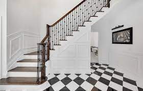 Cancos Tile Stone Featured In This Stunning Black And White Entryway Graphic Patterns Create A Beautiful D White Foyer White Porcelain Tile Staircase Design