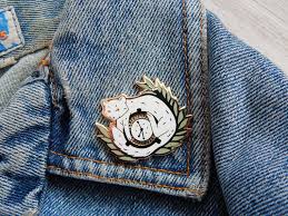 Pantalaimon And The Alethiometer Enamel Pin His Dark Etsy In 2020 His Dark Materials Dark Material Enamel Pins