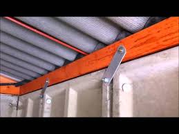 The layout of a sectional garage door includes several horizontal panels joined together by hinges that enable the door to bend and curve as it goes up and down. Hanson Royale Concrete Garage Youtube