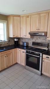 Black And Natural Wood Kitchen Cabinets Small Shaker Kitchen With Natural Stained Cabinets And Black Countertops Cabinets Com Maple Kitchen Cabinets Birch Kitchen Cabinets Kitchen Remodel Small