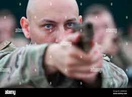 Security Forces Squadron flight chief Matthew Weaver salutes Staff Sgt.  Shannon Hutto, a military working dog trainer and Eddie, a Belgian Malinois  during a ceremony at MacDill Airforce Base in Tampa, Fla.,