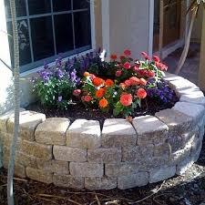 Building a block garden wall is easier if you use surface bonding cement instead of mortar. How To Build A Retaining Wall Flower Bed Ehow Stone Flower Beds Pretty Flowers Building A Retaining Wall