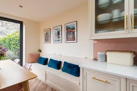 A sofa fits perfectly between cabinets in a kitchen nook. Kitchen Trends Banquette Seating Herringbone Kitchens