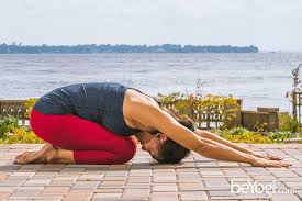 Mother and daughter practicing yoga. Child S Pose Balasana Beyogi
