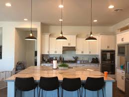 An immaculately arranged nightstand includes a. A Large Kitchen Island With Our Classic Black Metal Barn Pendant Lights Kitchen Remodel Kitchen Island Lighting Pendant Metal Pendant Light