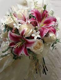 A classic handmade bridal shower bouquet with the flowers held in place by a bridal holder. Rose And Stargazer Bouquet Lily Bouquet Wedding Stargazer Lily Bouquet Stargazer Bouquet