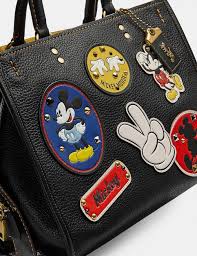 Disney x coach large corner zip wristlet with cinderella flying birds print. Coach Disney X Coach Rogue With Patches Big Apple Buddy