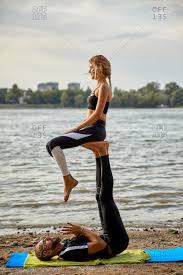 Here are 50 yoga poses for two people of any level to try with a friend or significant other! Young Man And Woman Practicing Acro Yoga Stock Photo Offset