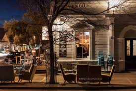 Table And Chairs Outside A Corner Cafe On Kitchener St In Martinborough Village At Dusk Corner Cafe Village Table And Chairs