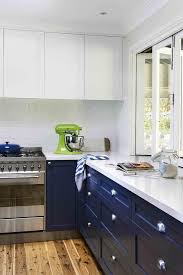 Sebring design build for more modern kitchen designs, choosing two contrasting tones can create a striking color scheme.this kitchen features bright white cabinets with a dramatic charcoal grey stacked stone backsplash. Navy Blue Bottom Kitchen Cabinets Design Ideas