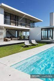 We did not find results for: Lounge Chairs And Swimming Pool Outside Modern House Real Estate Clear Sky Stock Photo 199881926