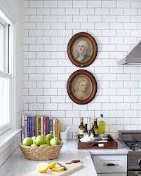 The white kitchen island and all white accessories—sans the sunny yellow mixer—add to the airy feel. 10 Kitchen Wall Decor Ideas Easy And Creative Style Tips Architectural Digest