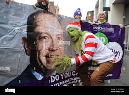 A person dressed as the Grinch as UNISON health workers deliver a message  from thousands of members, who have not received a pay rise, to the  Secretary of State Chris Heaton Harris,