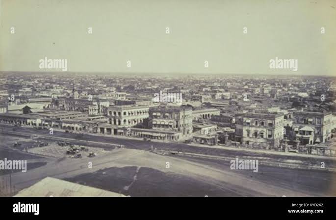 This 1865 photograph by Samuel Bourne captures a panoramic view of Calcutta (now Kolkata) from the Ochterlony Monument, showing the urban layout and colonial architecture of British India Stock Photo - Alamy