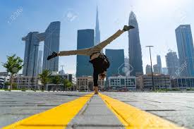 Learn more about it here. Flexible Acrobat Keep Balance On One Hand With Blurred Dubai Cityscape Concept Of Modern And Healthy Lifestyle Stock Photo Picture And Royalty Free Image Image 141500236