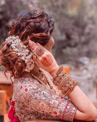 A bun is a type of hairstyle in which the hair is pulled back from the face, twisted or plaited, and wrapped in a circular coil around itself, typically on top or back of the head or just above the neck. Gorgeous Gajra Hairstyles You Need To Pin Down For Your Wedding