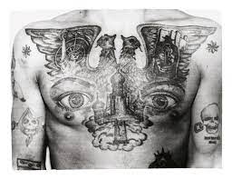 The 'thieves' stars' on the knees carry the symbolic meaning 'i will not kneel before the police'. The Secret Meanings Behind Russian Prison Tattoos