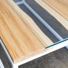 Handcrafted using poplar hardwood, it features turquoise tempered glass insert resembling a flowing river. Belmont Live Edge Glass River Coffee Table Hugo Hoby