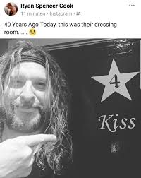 Gene Simmons wearing podkisst and kiss room buttons