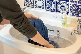 Tamraght, morocco washing clothes by hand and feet as we do laundry in a bathtub. Practical Guide To Doing Laundry While Traveling All You Need To Know
