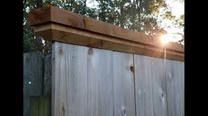 When you have the post perfectly upright, attach to lengths of lumber to the top of the post and stake. Trim Your Fence With Cap Board Youtube