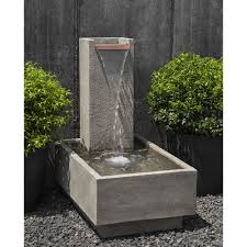 It features a large square backplate, with three large spouts, which frames an elevated rectangular basin. Floor Outdoor Falling Water Iv Fountain Kinsey Garden Decor
