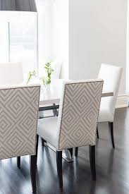 A Black Drum Pendant With Crystals Illuminate A Gray X Based Dining Table Lined With White And Dining Room Seating Dining Room Contemporary Dinning Room Chairs