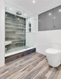 Artistic Tile I Our Wood Look Kauri Plank In Tasman Blue Adds Refinement And Warmth To This Upper Wood Tile Bathroom Wood Tile Shower Wood Look Tile Bathroom