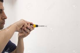 Man Screwing A Screw With Screwdriver And Copy Space Stock Photo, Picture  And Royalty Free Image. Image 18939814.