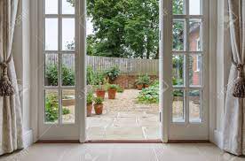 Installing french doors isn't an easy task, but with these helpful instructions, the end result is worth the extra work. View Of Garden From Inside House With French Doors Leading To Stock Photo Picture And Royalty Free Image Image 127565860
