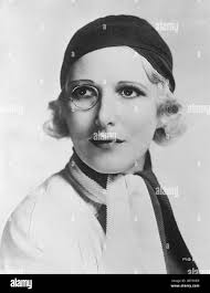 The monocled star . Heather Thatcher , the English actress with her monocle  , and a new black and white scarf worn with a close fitting wool hat of  black . 3 May 1932 Stock Photo