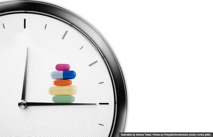 Weekly pill organizer and clock, representing the role of routine and timing in how medicine is taken